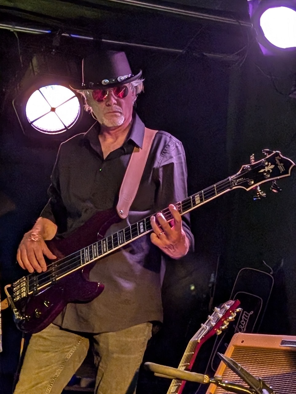 Chango Monks bassist performing in a black hat